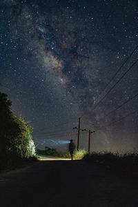 Preview wallpaper road, light, man, alone, night, starry sky