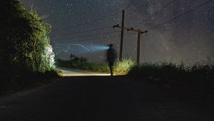 Preview wallpaper road, light, man, alone, night, starry sky