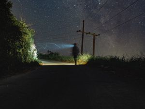 Preview wallpaper road, light, man, alone, night, starry sky