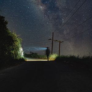 Preview wallpaper road, light, man, alone, night, starry sky