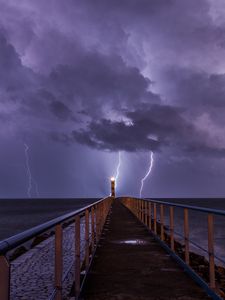 Preview wallpaper road, lighthouse, lightning, sea, dark, clouds