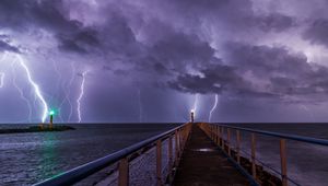 Preview wallpaper road, lighthouse, lightning, sea, dark, clouds