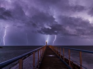 Preview wallpaper road, lighthouse, lightning, sea, dark, clouds