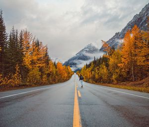 Preview wallpaper road, man, mountains, trees, autumn
