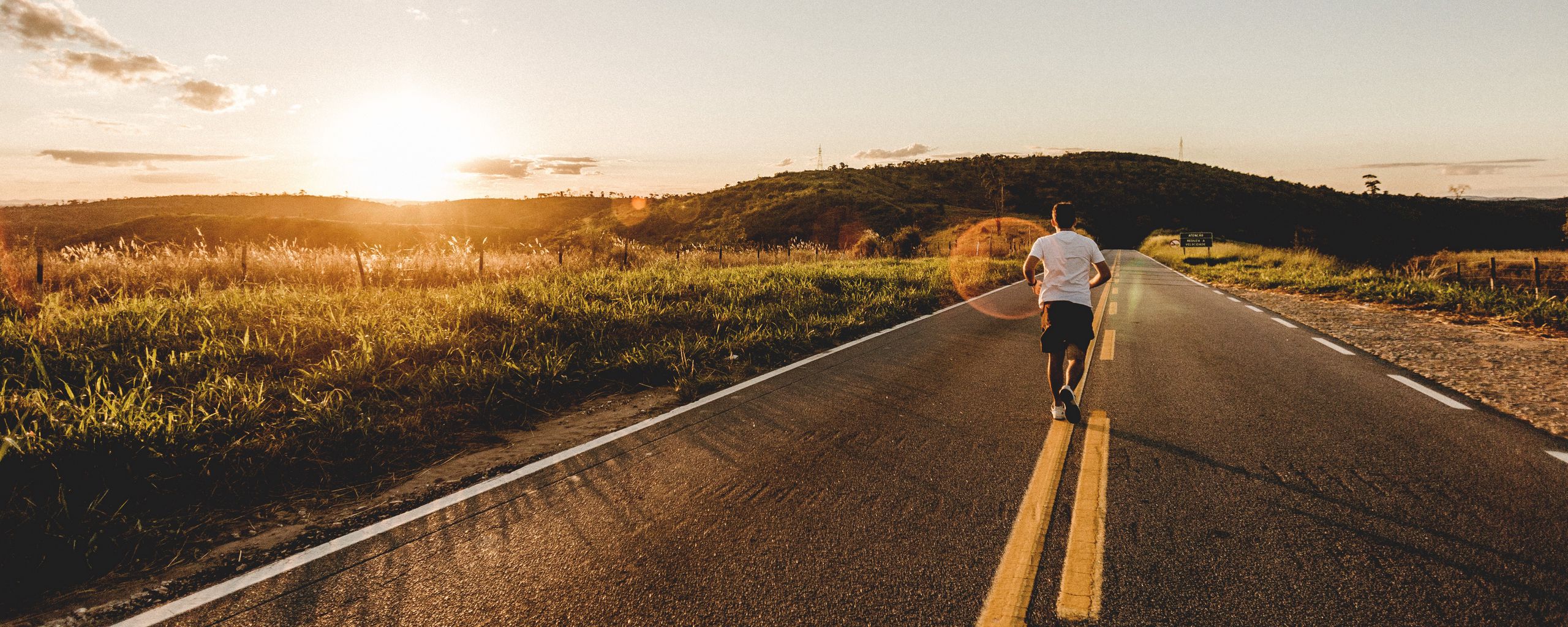 Download wallpaper 2560x1024 road, man, run, asphalt, jog ultrawide