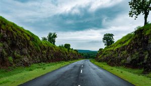 Preview wallpaper road, marking, grass, rocks, distance