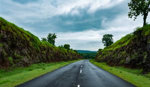 Preview wallpaper road, marking, grass, rocks, distance