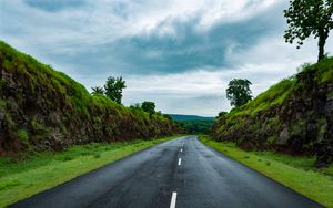 Preview wallpaper road, marking, grass, rocks, distance