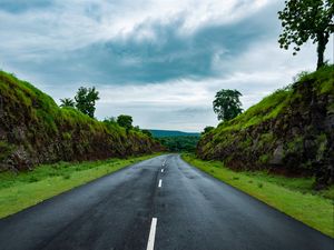 Preview wallpaper road, marking, grass, rocks, distance