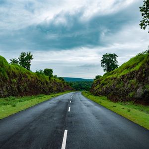 Preview wallpaper road, marking, grass, rocks, distance