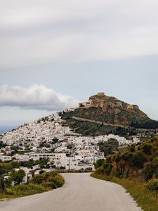 Preview wallpaper road, mountain, buildings, city