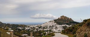 Preview wallpaper road, mountain, buildings, city