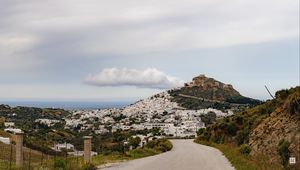 Preview wallpaper road, mountain, buildings, city