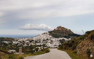 Preview wallpaper road, mountain, buildings, city