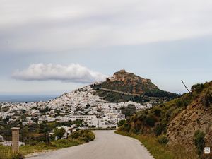 Preview wallpaper road, mountain, buildings, city
