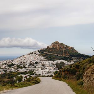 Preview wallpaper road, mountain, buildings, city