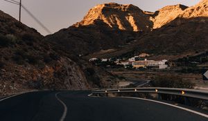 Preview wallpaper road, mountains, buildings, asphalt, winding