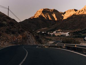 Preview wallpaper road, mountains, buildings, asphalt, winding