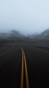 Preview wallpaper road, mountains, fog, turn, rocks