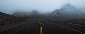 Preview wallpaper road, mountains, fog, turn, rocks