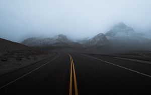 Preview wallpaper road, mountains, fog, turn, rocks