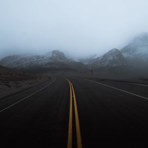 Preview wallpaper road, mountains, fog, turn, rocks