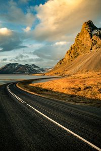 Preview wallpaper road, mountains, rocks, water, turn