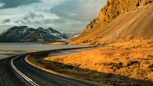 Preview wallpaper road, mountains, rocks, water, turn