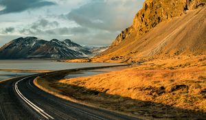 Preview wallpaper road, mountains, rocks, water, turn