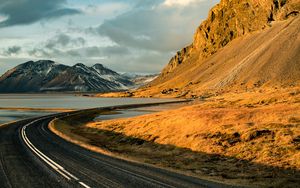 Preview wallpaper road, mountains, rocks, water, turn