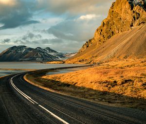 Preview wallpaper road, mountains, rocks, water, turn