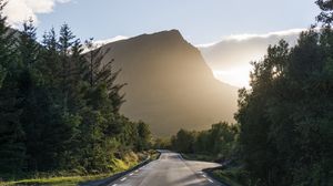 Preview wallpaper road, mountains, trees, dawn, nature