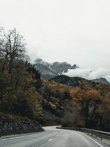 Preview wallpaper road, mountains, turn, trees, clouds
