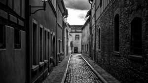 Preview wallpaper road, paving stones, houses, buildings, street, black and white