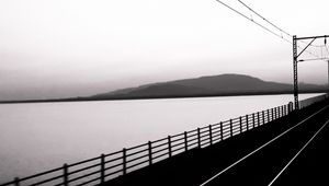 Preview wallpaper road, rails, bw, hill, water