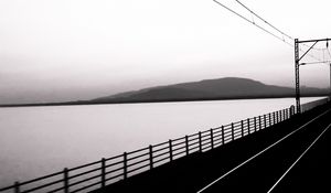 Preview wallpaper road, rails, bw, hill, water