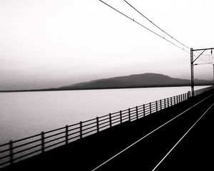 Preview wallpaper road, rails, bw, hill, water