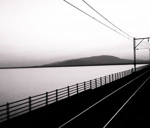 Preview wallpaper road, rails, bw, hill, water