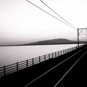 Preview wallpaper road, rails, bw, hill, water