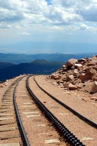 Preview wallpaper road, rails, cross ties, desert, stones, sand, day