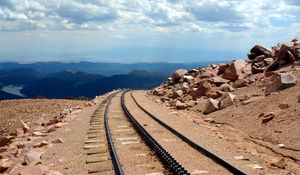 Preview wallpaper road, rails, cross ties, desert, stones, sand, day