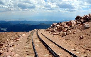 Preview wallpaper road, rails, cross ties, desert, stones, sand, day