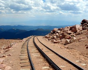 Preview wallpaper road, rails, cross ties, desert, stones, sand, day