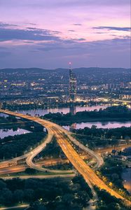 Preview wallpaper road, river, buildings, lights, city, twilight