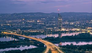 Preview wallpaper road, river, buildings, lights, city, twilight