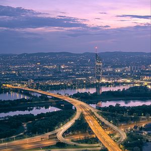 Preview wallpaper road, river, buildings, lights, city, twilight