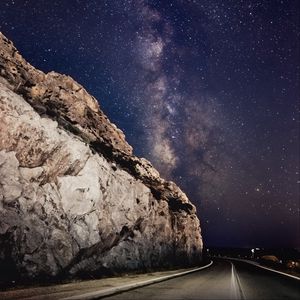 Preview wallpaper road, rocks, starry sky, stars, night