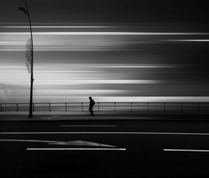 Preview wallpaper road, silhouette, bw, long exposure, blur