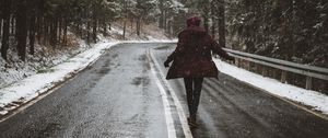 Preview wallpaper road, silhouette, trees, turn, snow, asphalt, wet