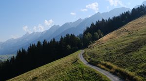 Preview wallpaper road, slope, trees, mountains, landscape, nature